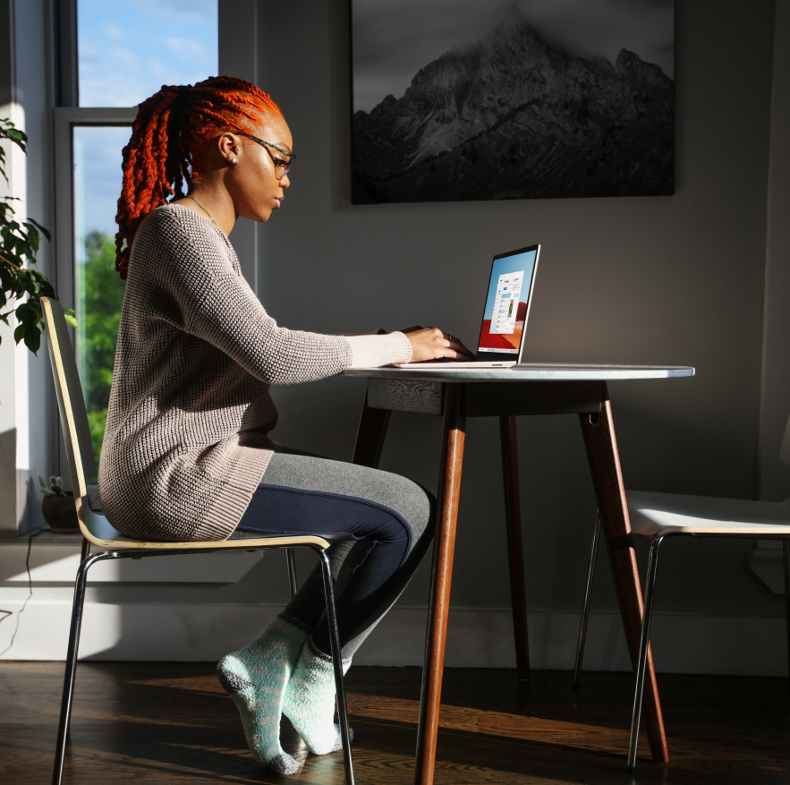 A woman engrossed in her laptop, diligently
immersed in her tasks.