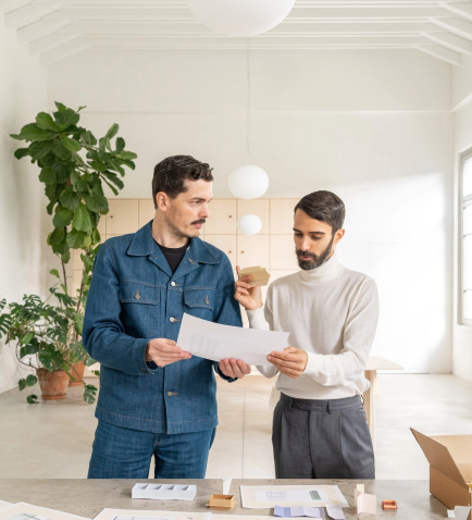 Two men engaged in a dialogue, exploring optimal approaches for redesign